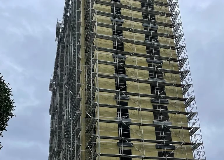 Site photo of façade and insulation works on scaffolding